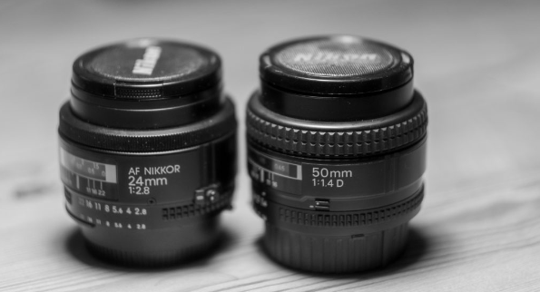 The Nikon 50mm to the right with the wider manual focus ring.