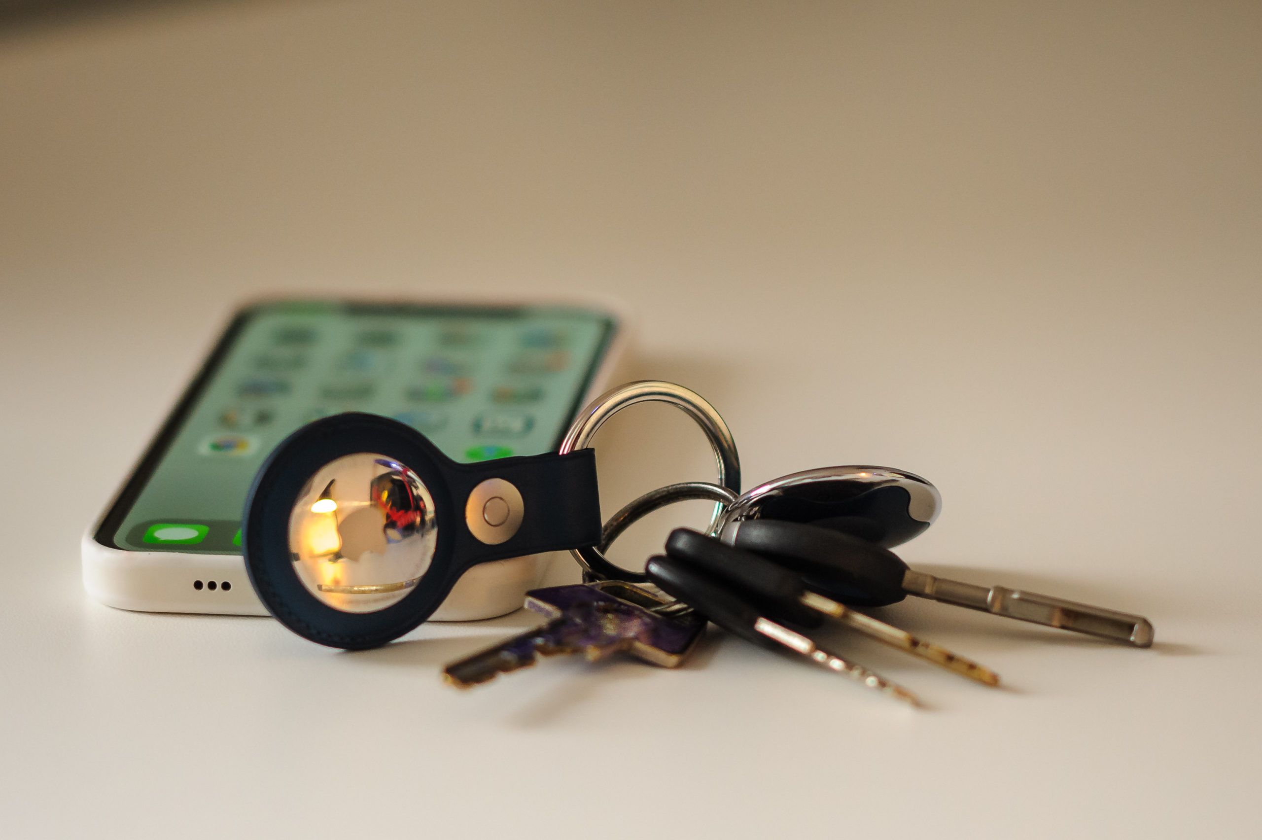 IPhone 12 and keys with the AirTag and Leather Key ring.